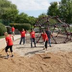 Volunteers moving and shoveling the new dirt