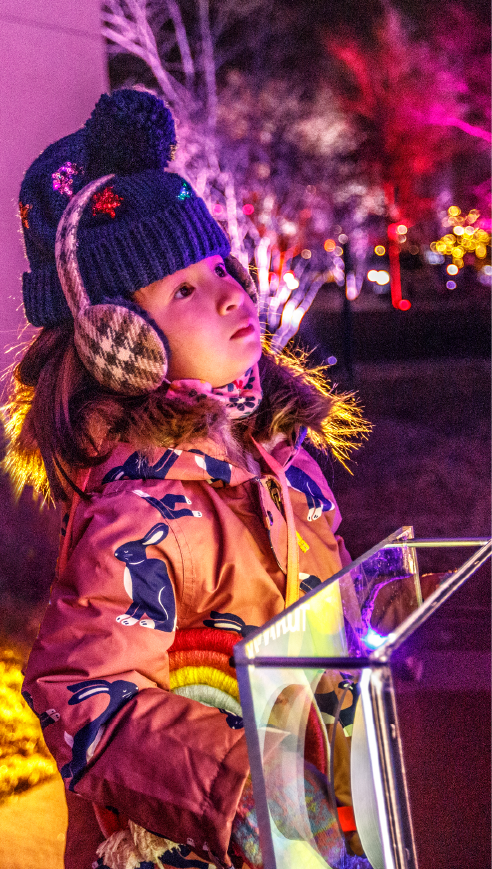 girl turning the handle to change the color of lights