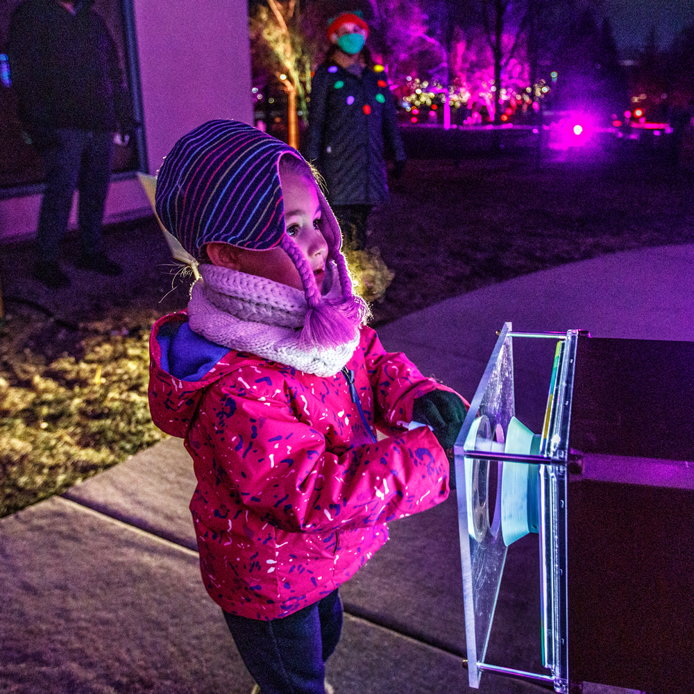 young child interacting with lights